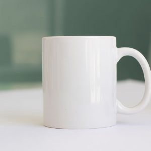 Tienda A simple white ceramic mug placed on a tabletop, perfect for product mockups.